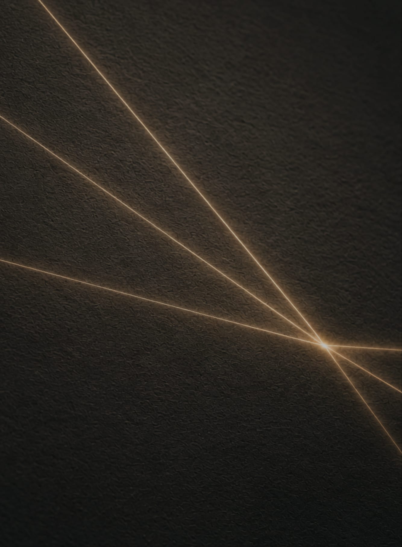 Golden light rays converging on a single point across a textured dark surface