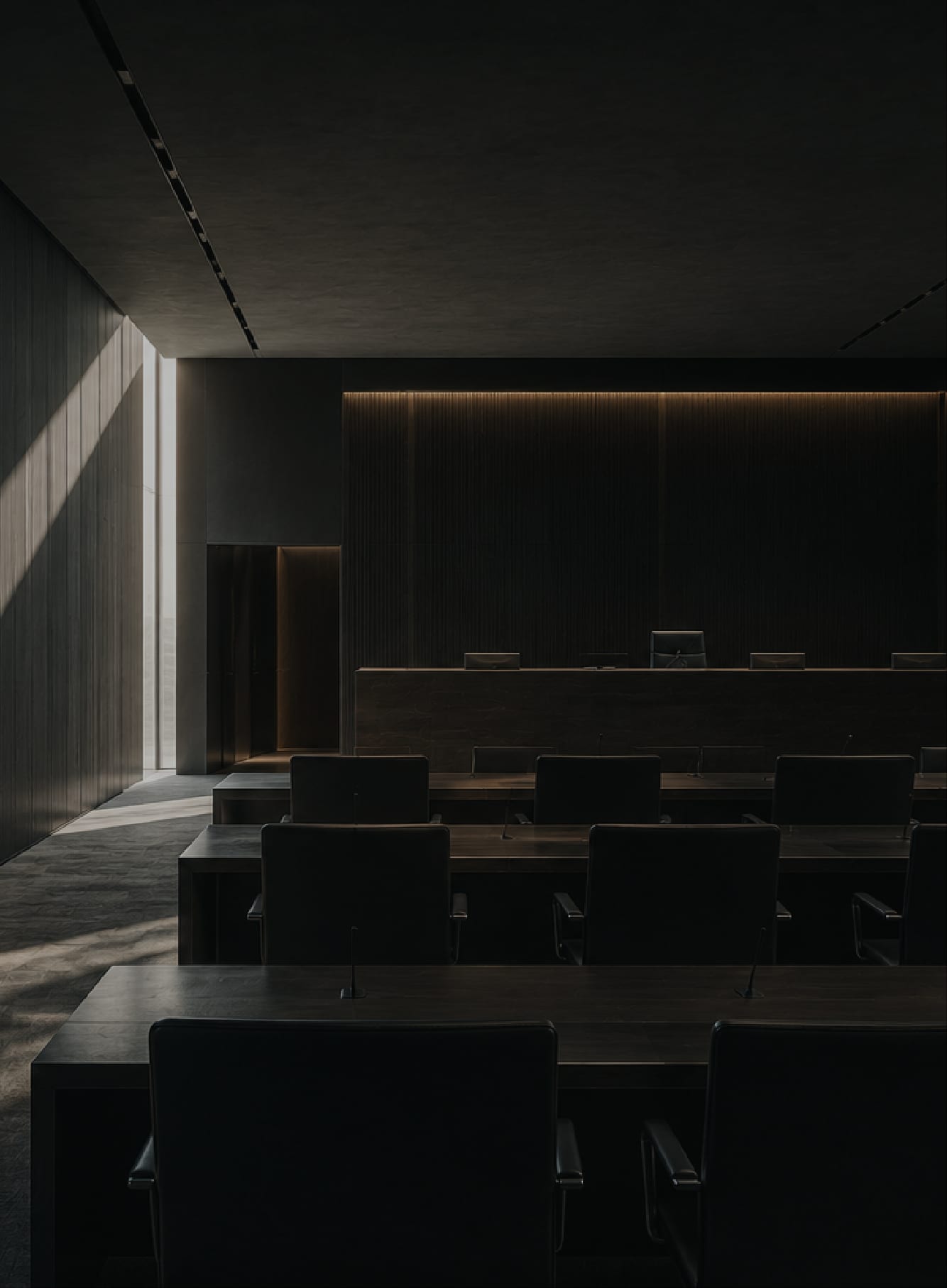 Modern executive boardroom in low light with directional natural light